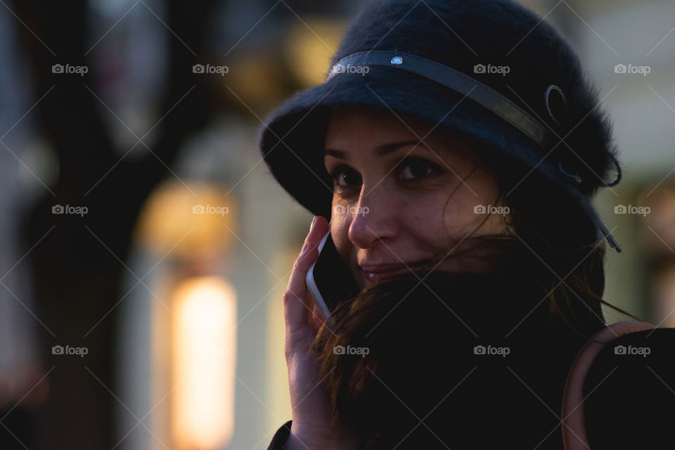 Young woman smiling using smartphone