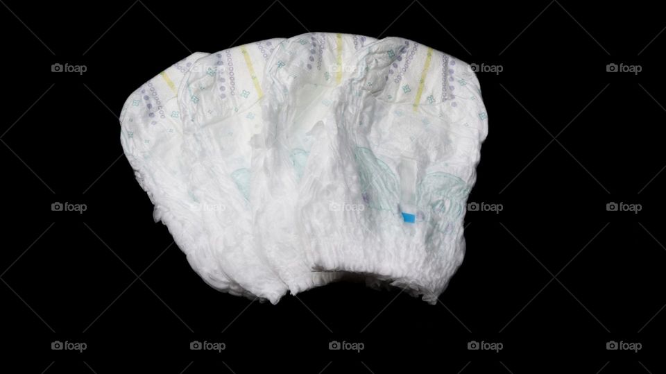Baby diapers stacked each other on isolated background.