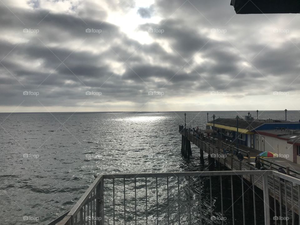 Light shining through the clouds over the ocean on the first day of autumn 