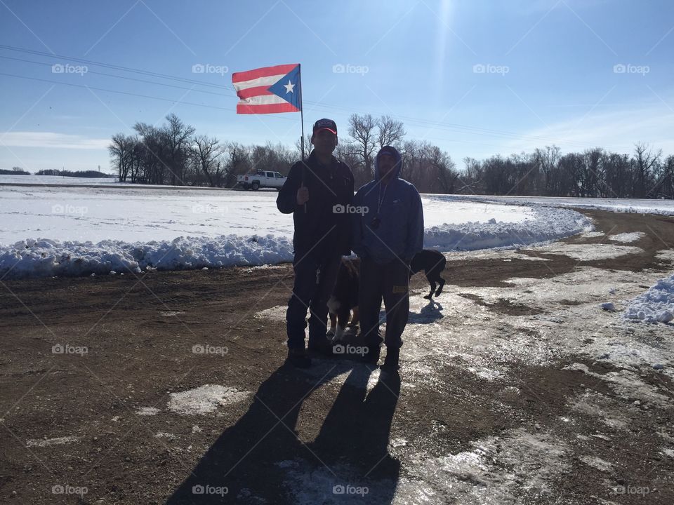 Sisseton Wahpeton Sioux Tribe guest with his Puerto Rican flag, during Winter
