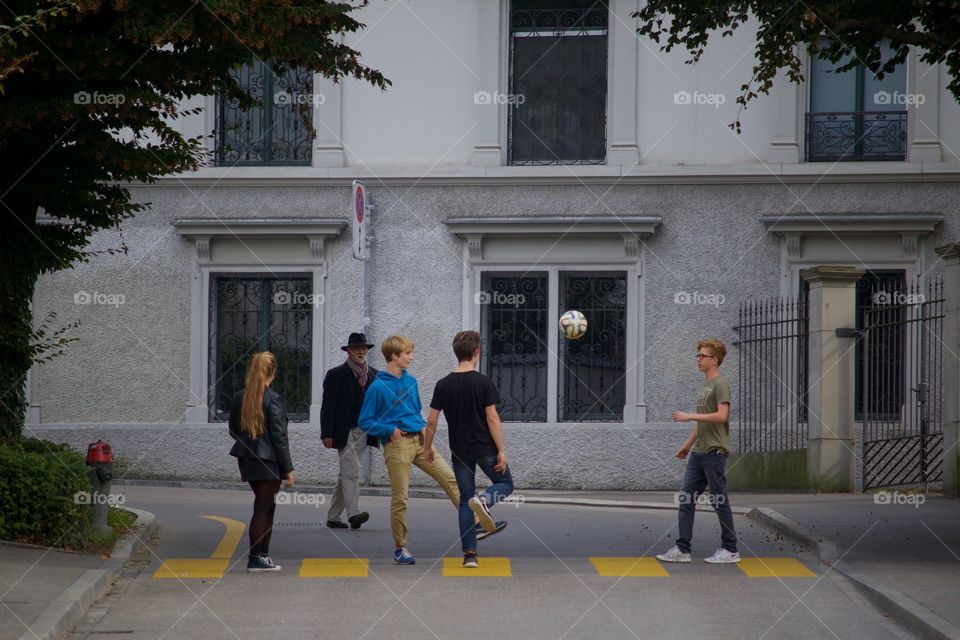 Shot Of Teenagers Playing Football In  A Street In Zürich