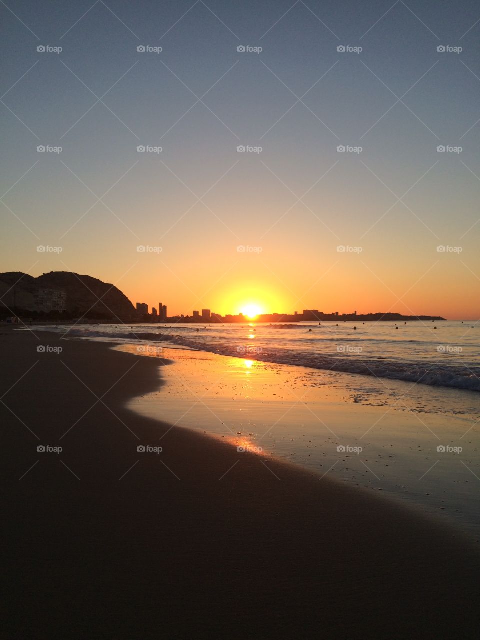 Sunrise on the beach. The sunrise from Playa del Postiguet in Alicante, Spain
