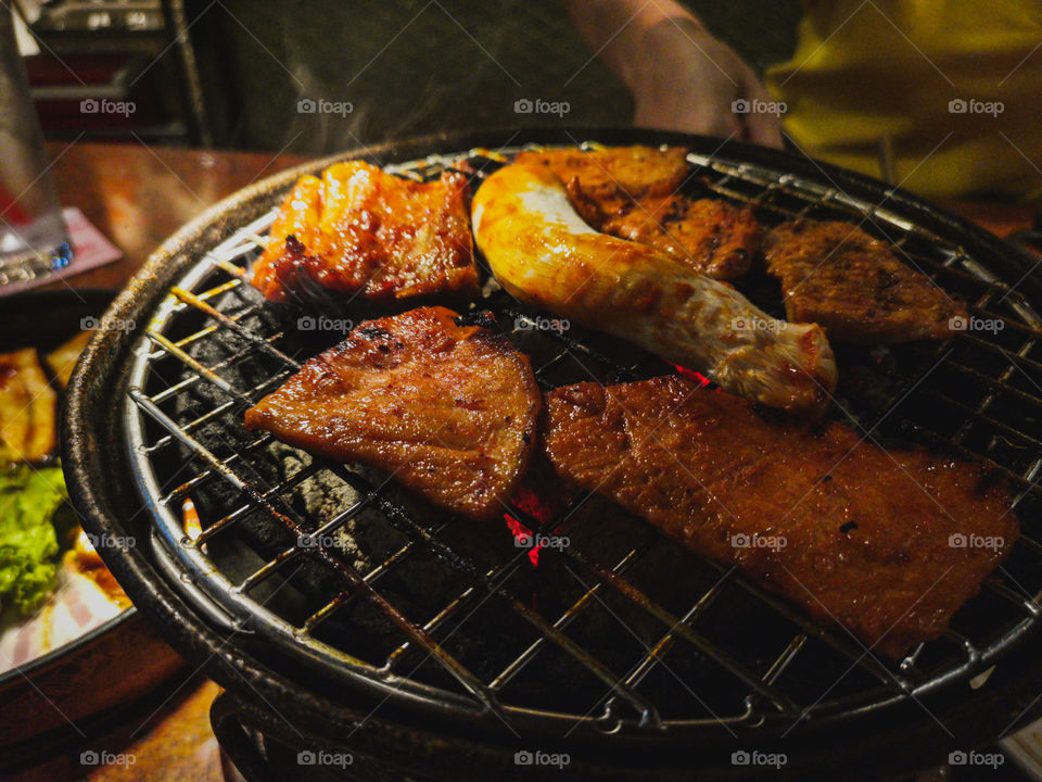 Grilled marinated pork on a charcoal grill