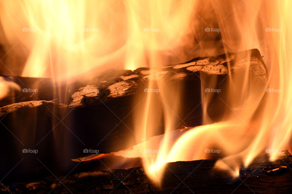 log burning in a fire place in close up