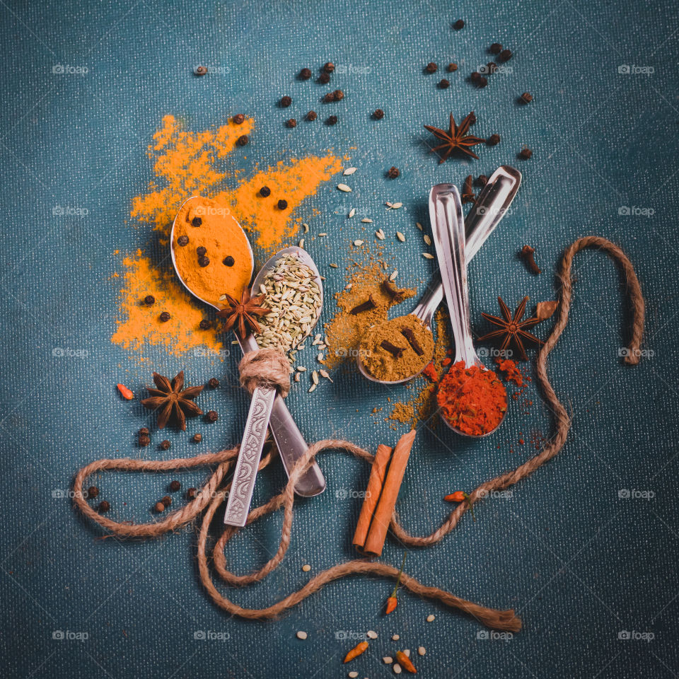 Spices isolated on blue background.