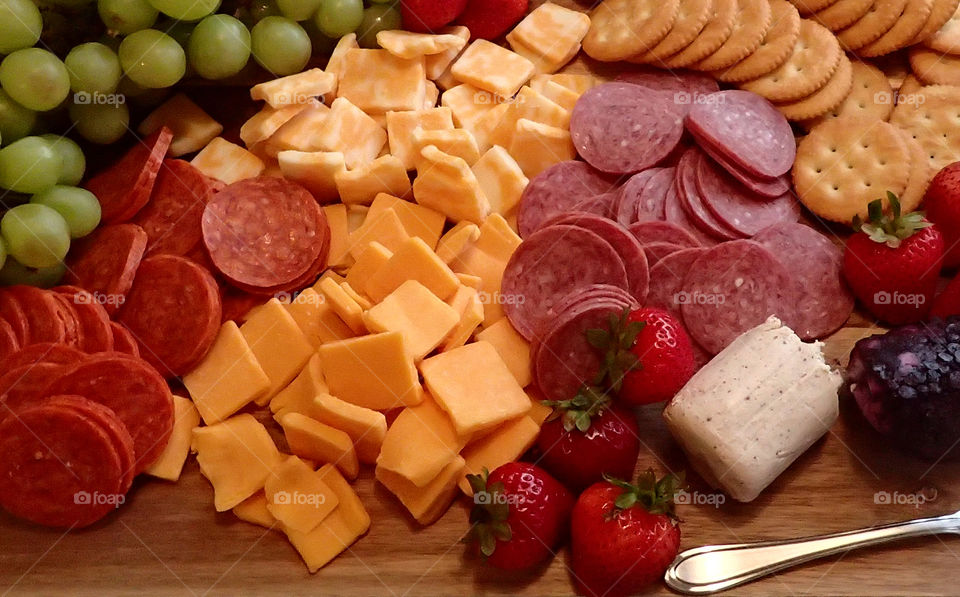 Cheese crackers pepperoni grapes strawberries munchies