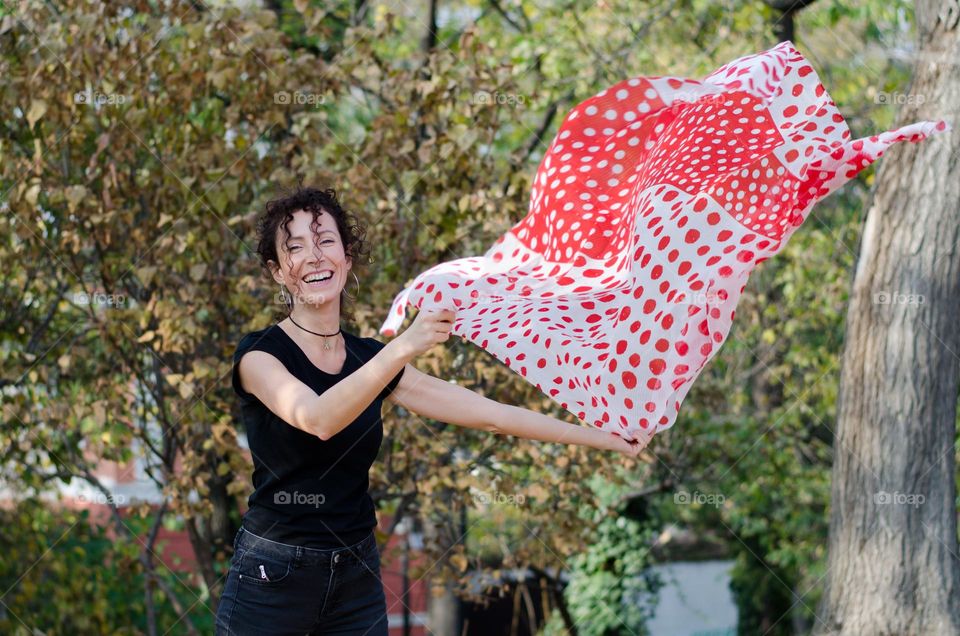 Beautiful Young Woman Dancing with Scarf Outside in Nature