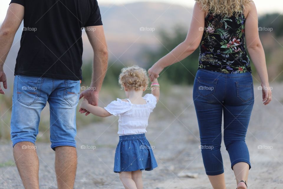 Daughter holding father and mother hands