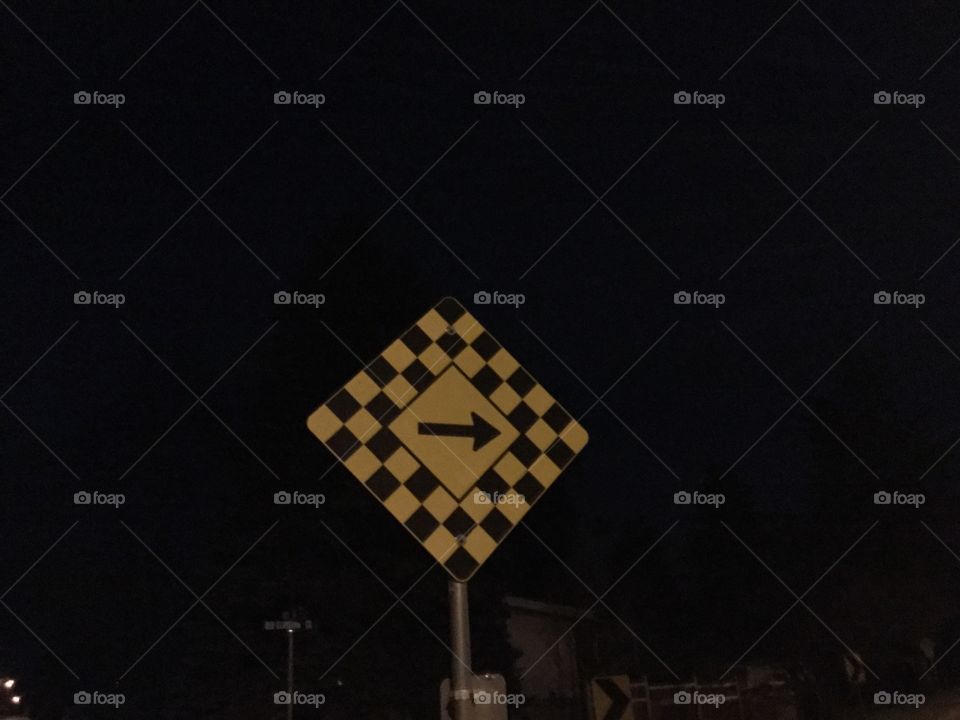 A Road Blocked, Turn Right sign on the Street Corner on a Spring Night 