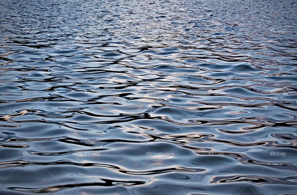 Soft wavy lake surface with light reflections