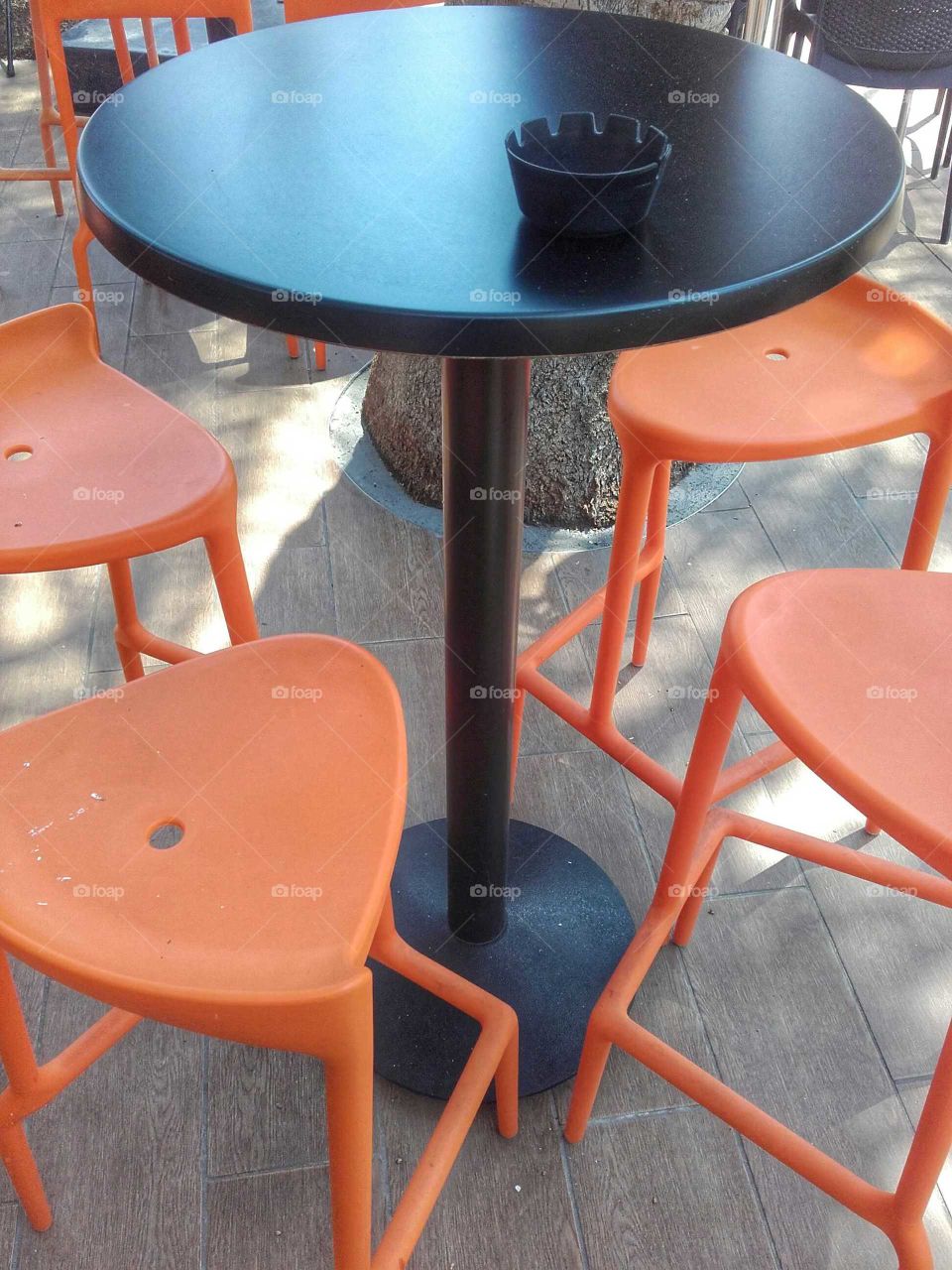 Black table with orange stools