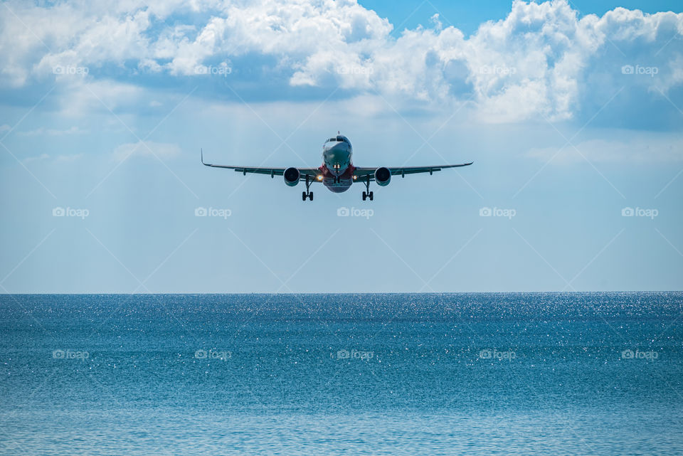 Airplane landing into port at Beautiful sea scape view in the southern of Thailand