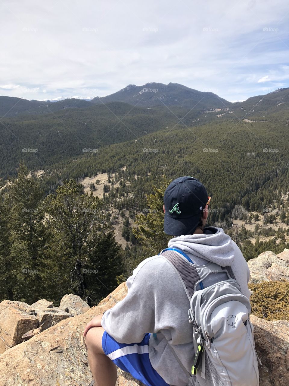 Beautiful day hike to a peak that looks directly over a valley with the Rocky Mountains in the background. Here I am relaxing after reaching the top