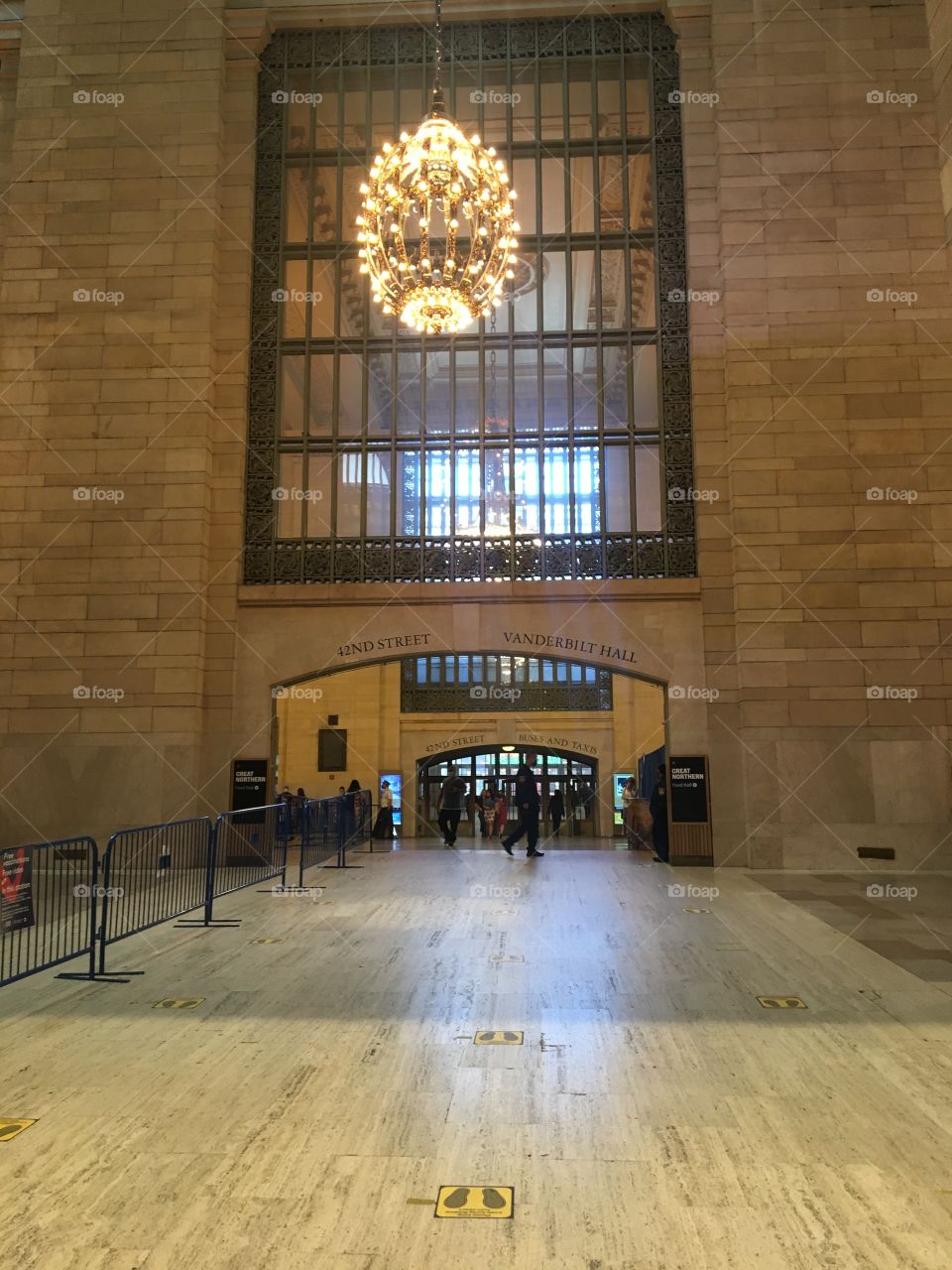 Empty entrance to New York City’s Grand Central Terminal at midday on a Monday in May (2021) with signs showing where to stand and space as coronavirus pandemic appears to winds down