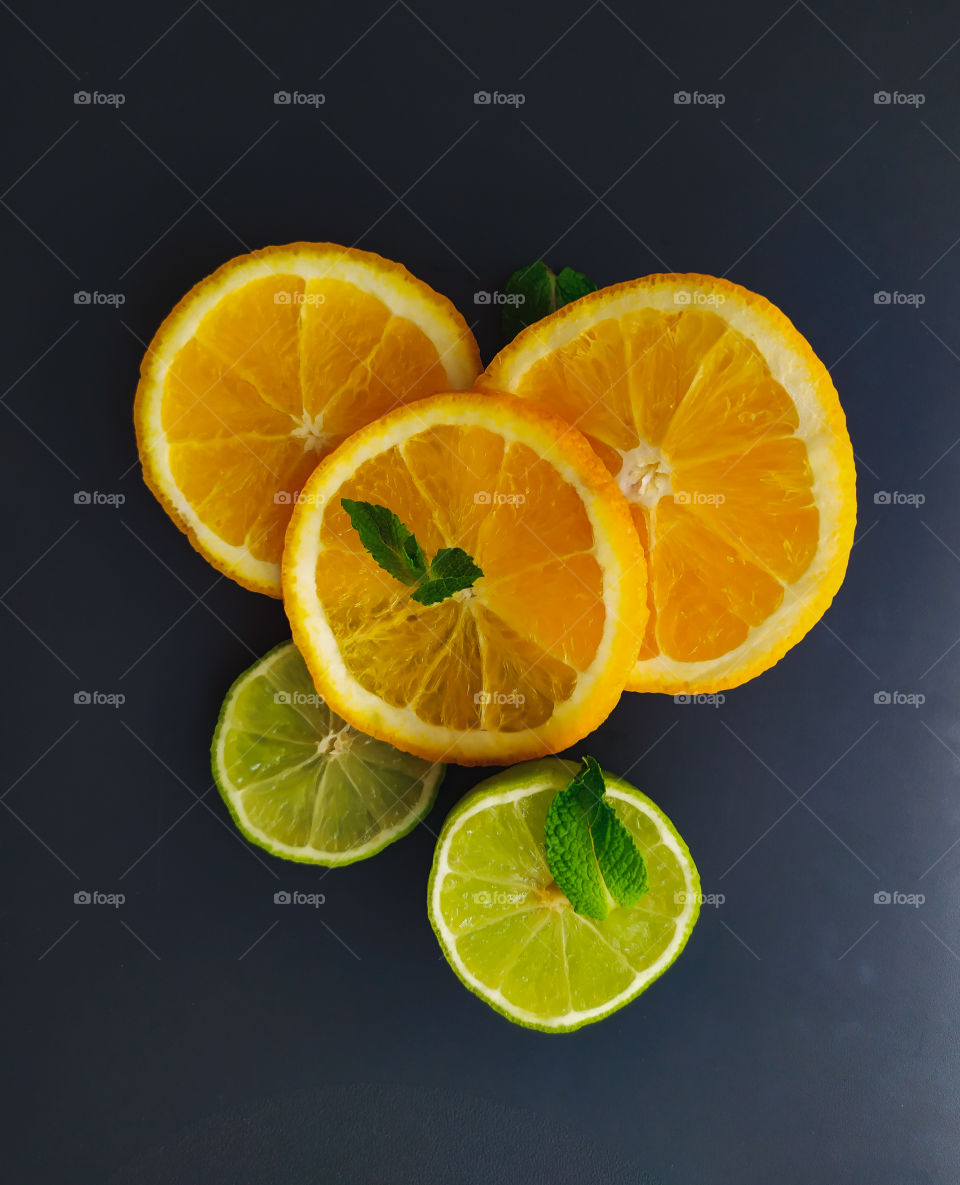 Sliced orange and lime slices with ice cubes
