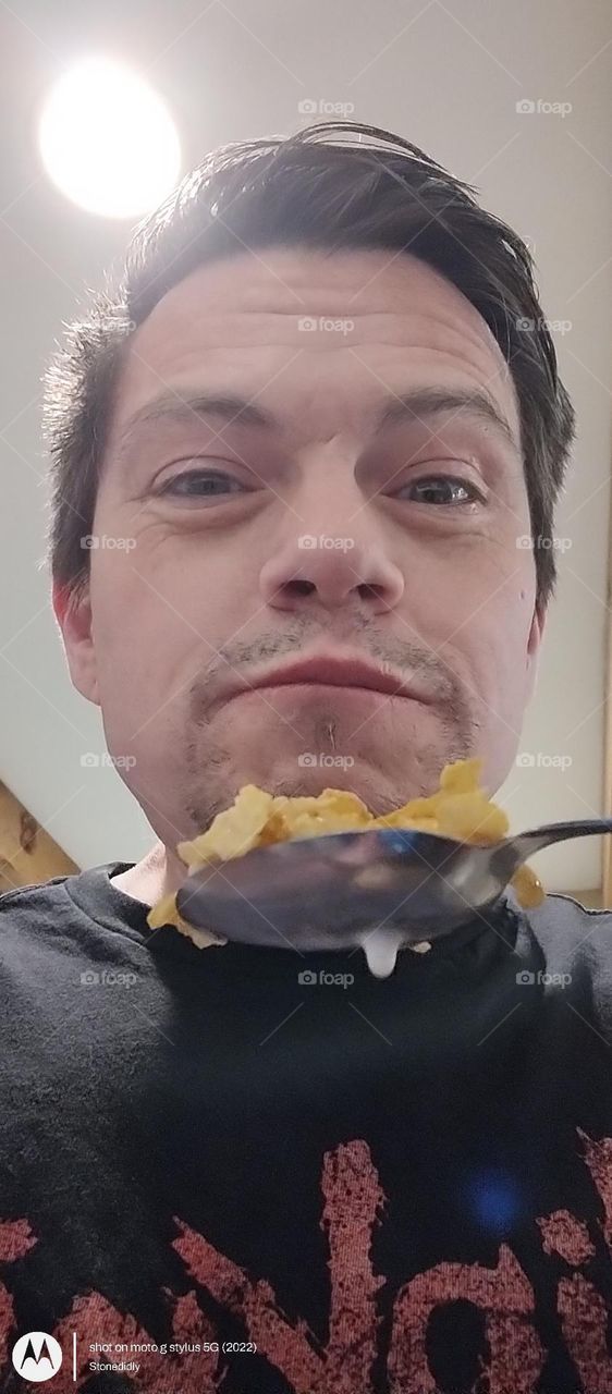 breakfast with Tim
man eating cereal
man eats cornflakes
