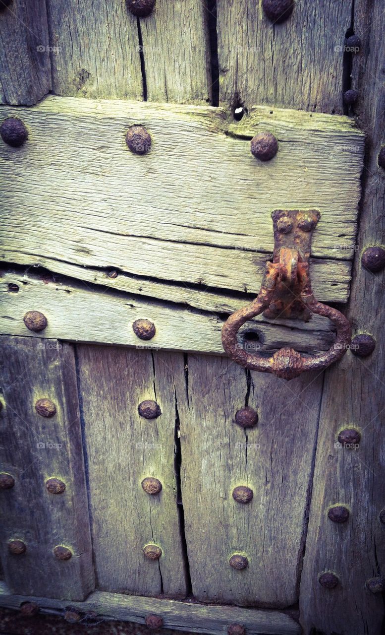 Close-up of ancient wooden door with grunge knob