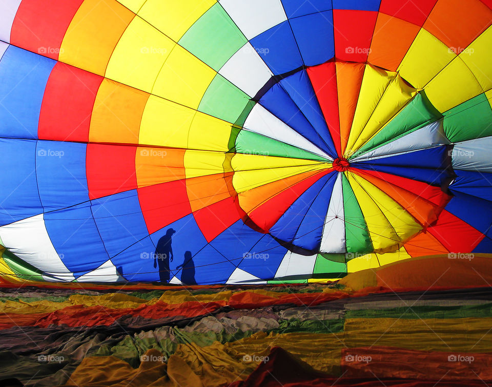 Silhouette of people behind a hot air balloon