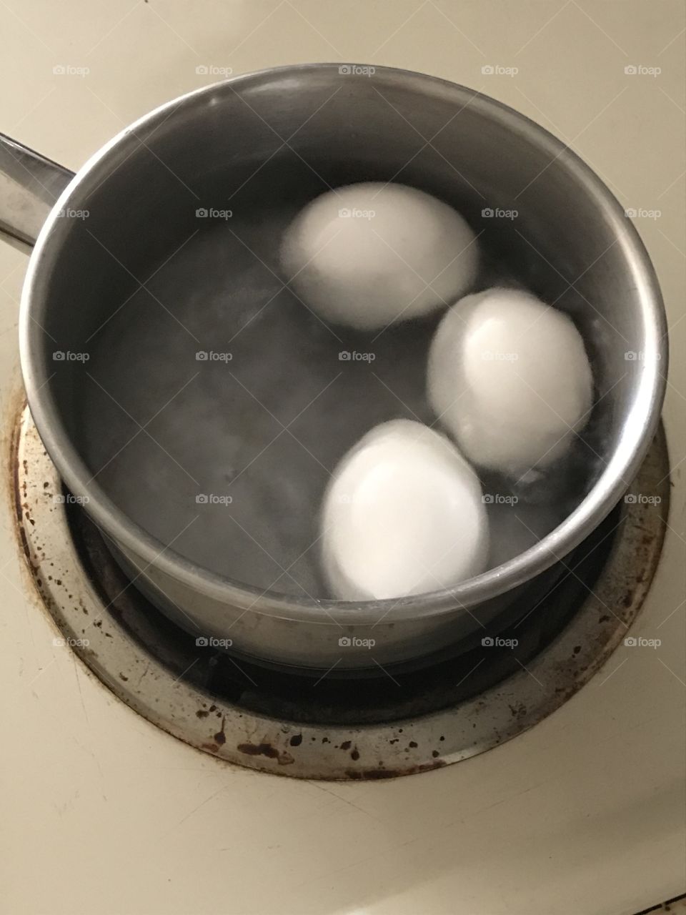 Eggs broiled in a pan of water to the boiling point. A simple way of preparing them for healthy consumption.