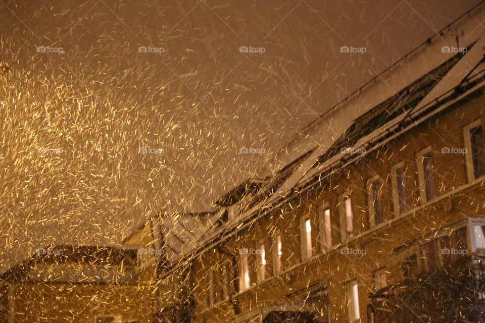 Golden snow. Snowing in the city