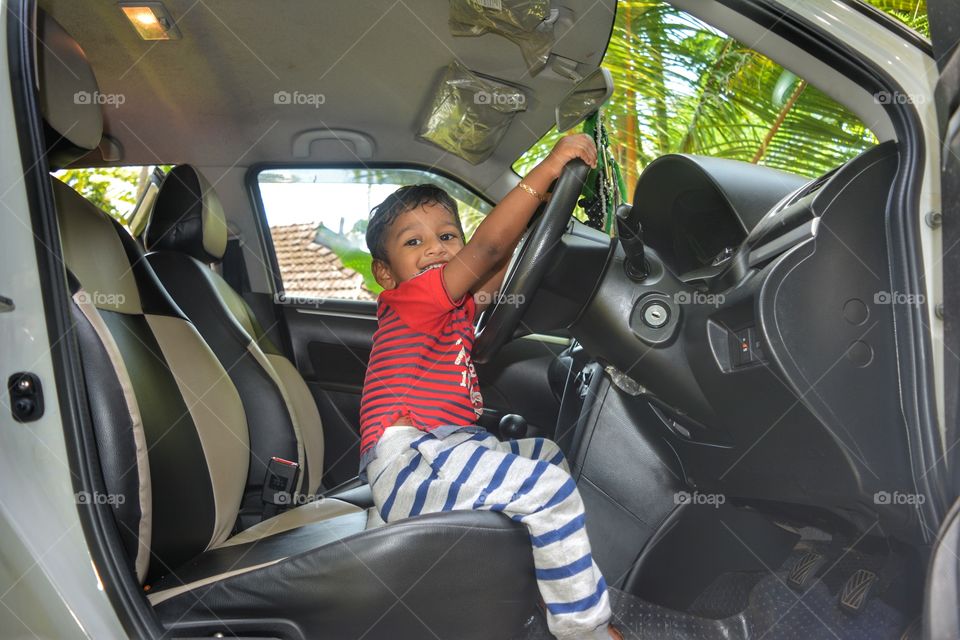baby boy playing in side car