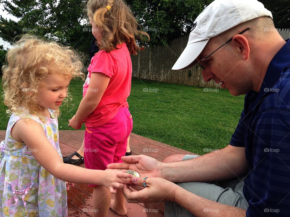 Look what I found!  Showing her Uncle the hermit crab she found...
