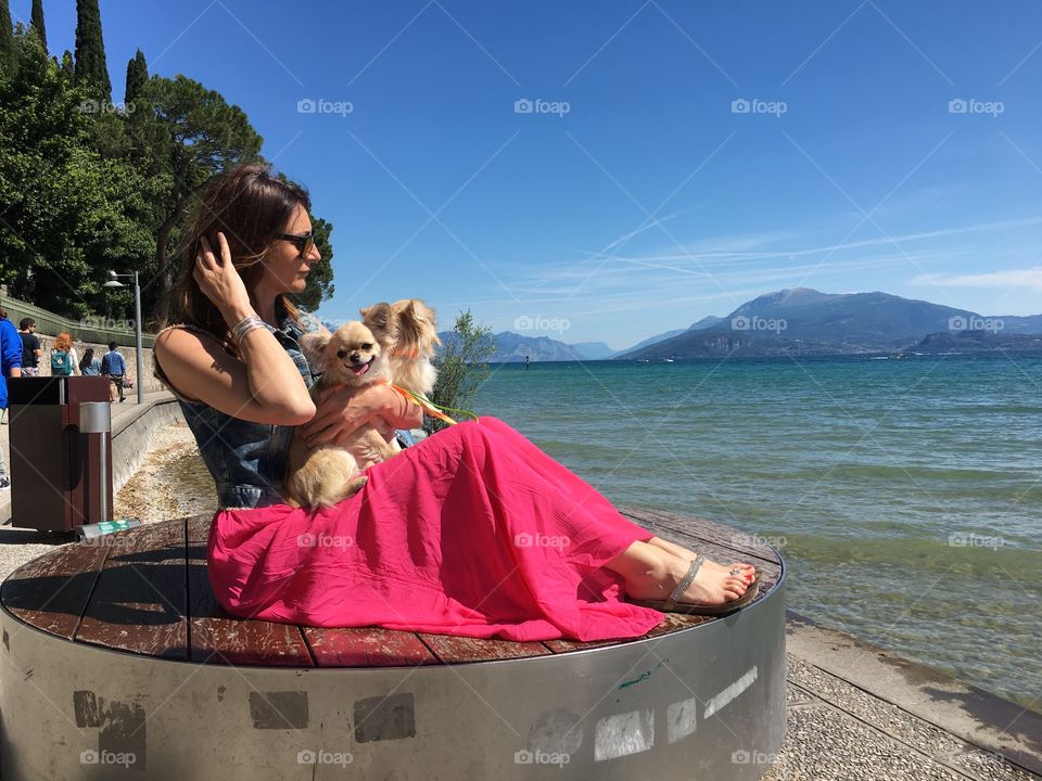Girl and dogs in Garda lake 