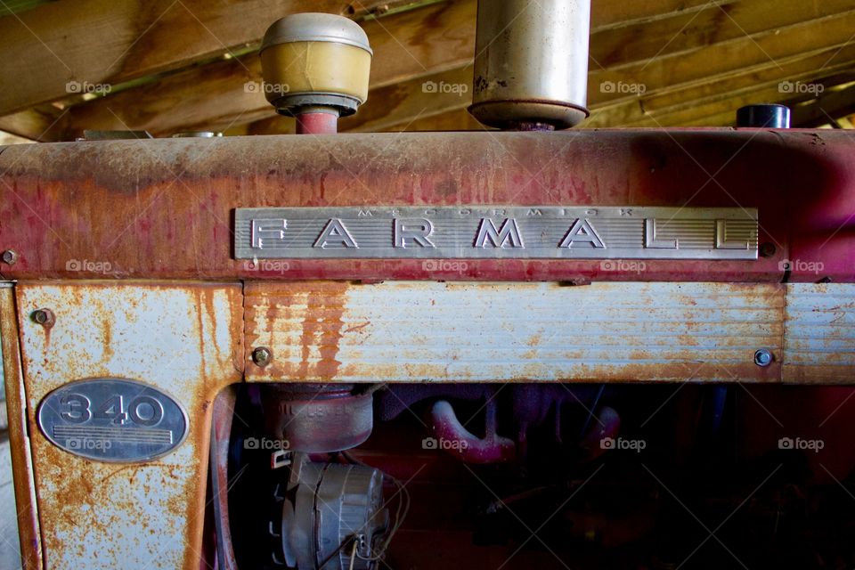 Antique International Farmall tractor in an old barn