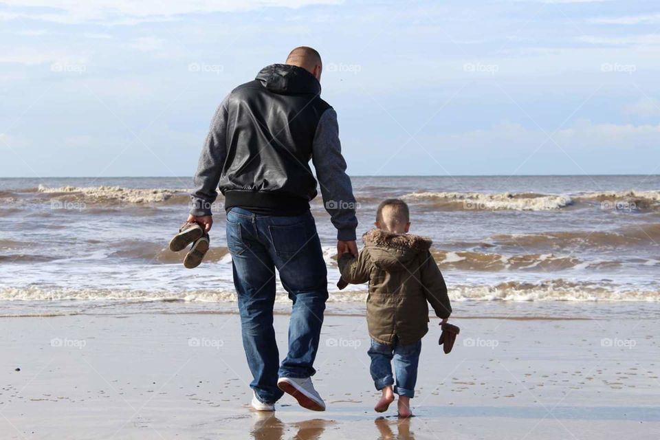 Father and son Beach holding hands
