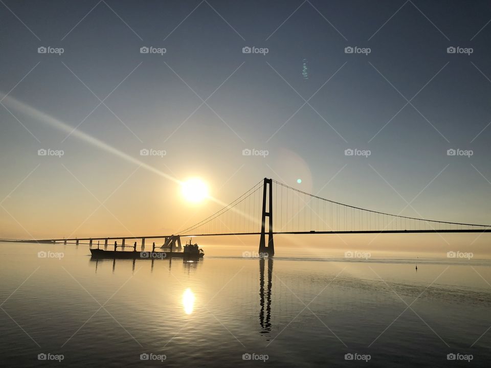 Baltic Sea,with a bridge and a ship on a golden sunset