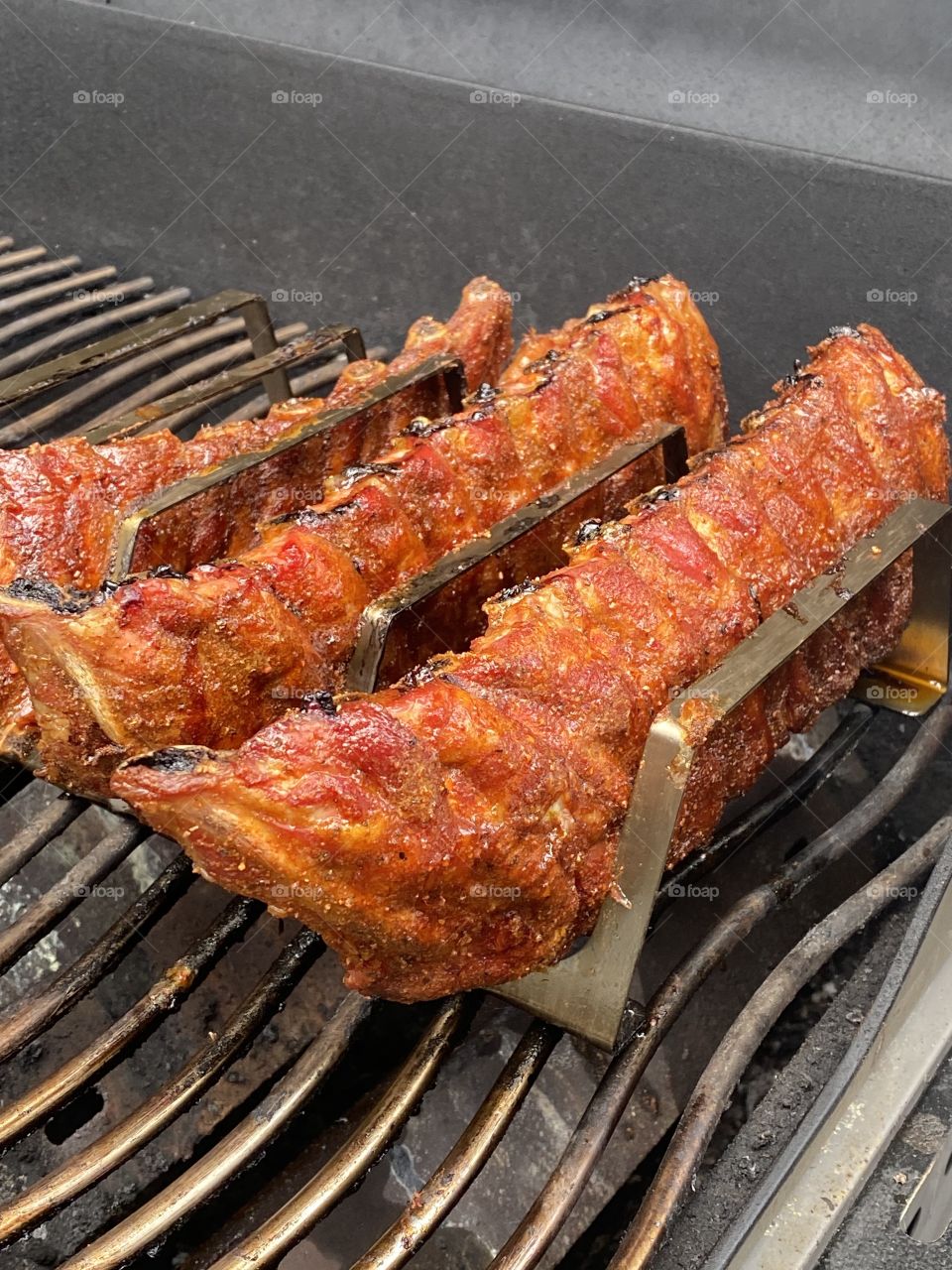 Spareribs with homemade rub on a barbecue 
