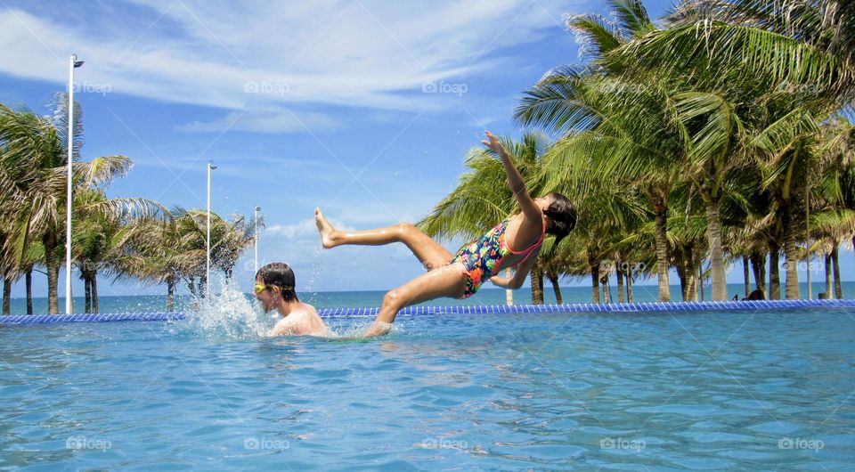 Two brothers having fun in the pool