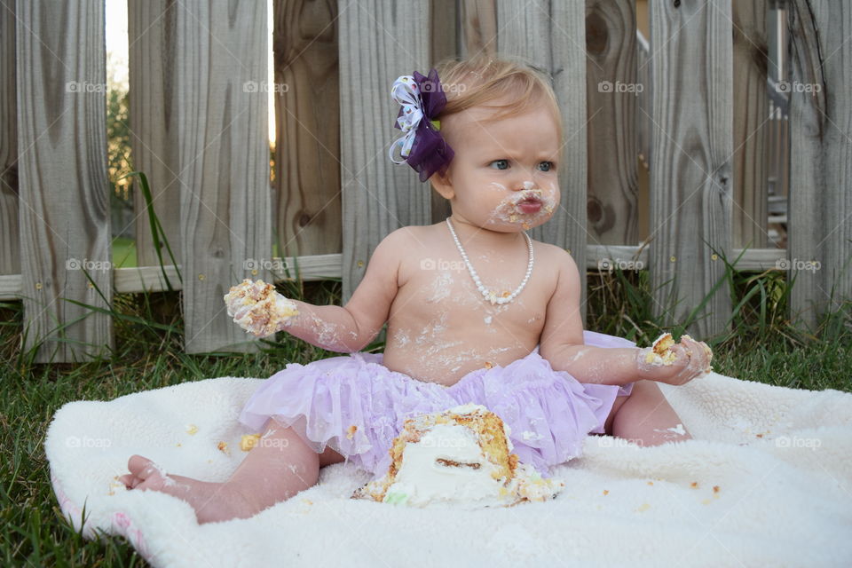 Close-up of a messy girl eating cake