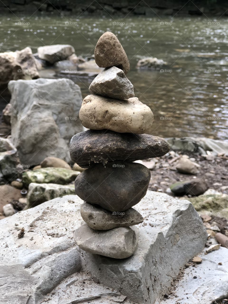 Enjoying the June Creekside rock stacking .