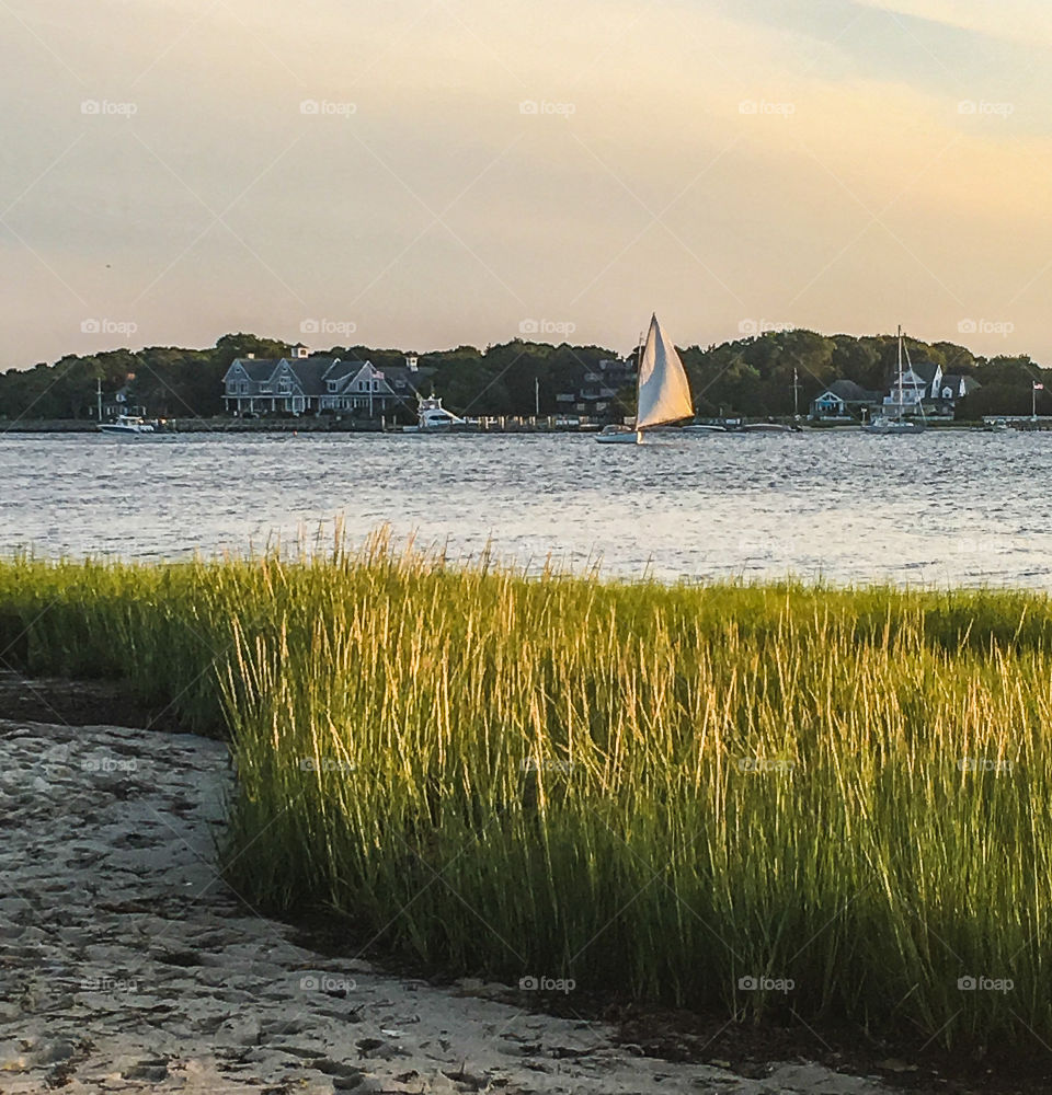 Sailboat at sunset.  Heading down the river, coming in from the ocean. She slowly made her way home. 