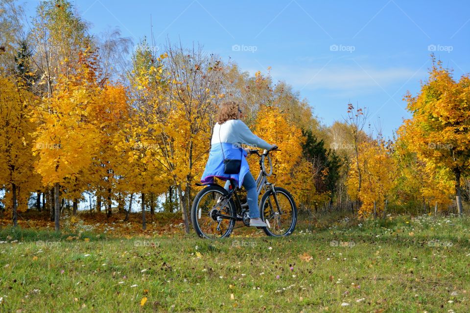 woman riding on a bike autumn beautiful landscape