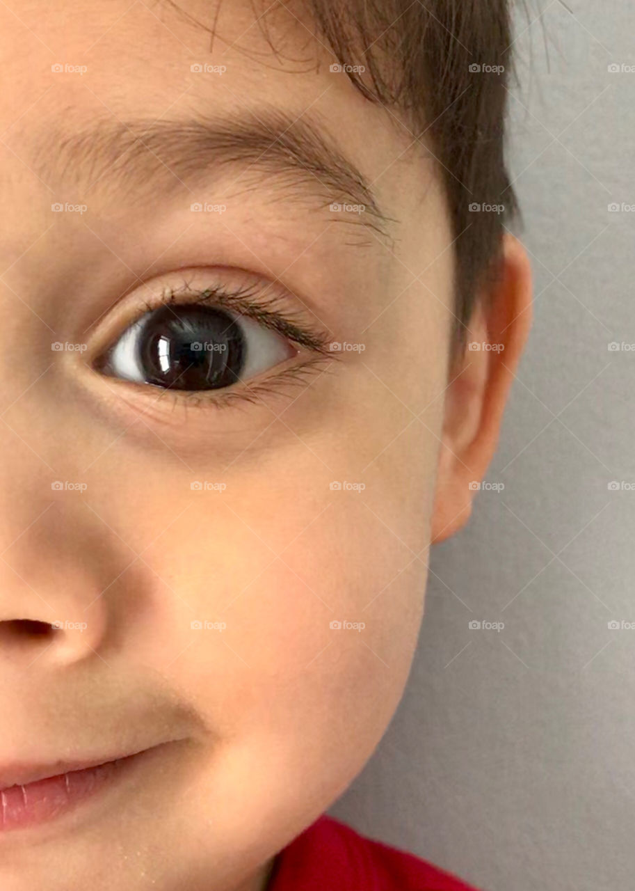 Half of a boy’s face with expression of excitement