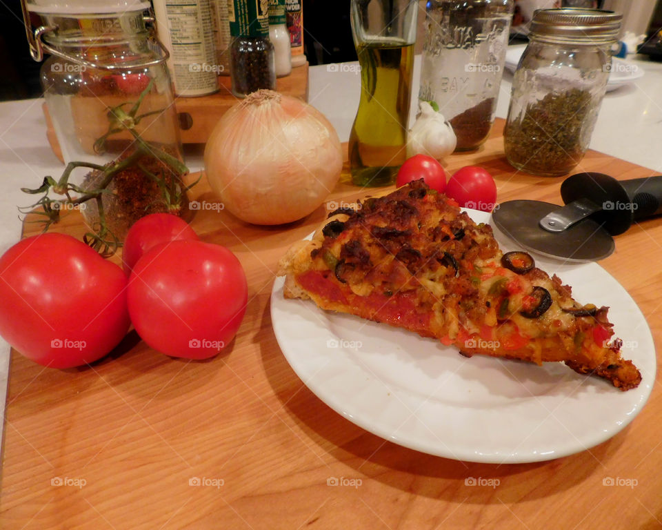 Delicious and nutritious homemade pizza with fresh, colorful vegetables, meats and a variety of spices! Grab a slice!