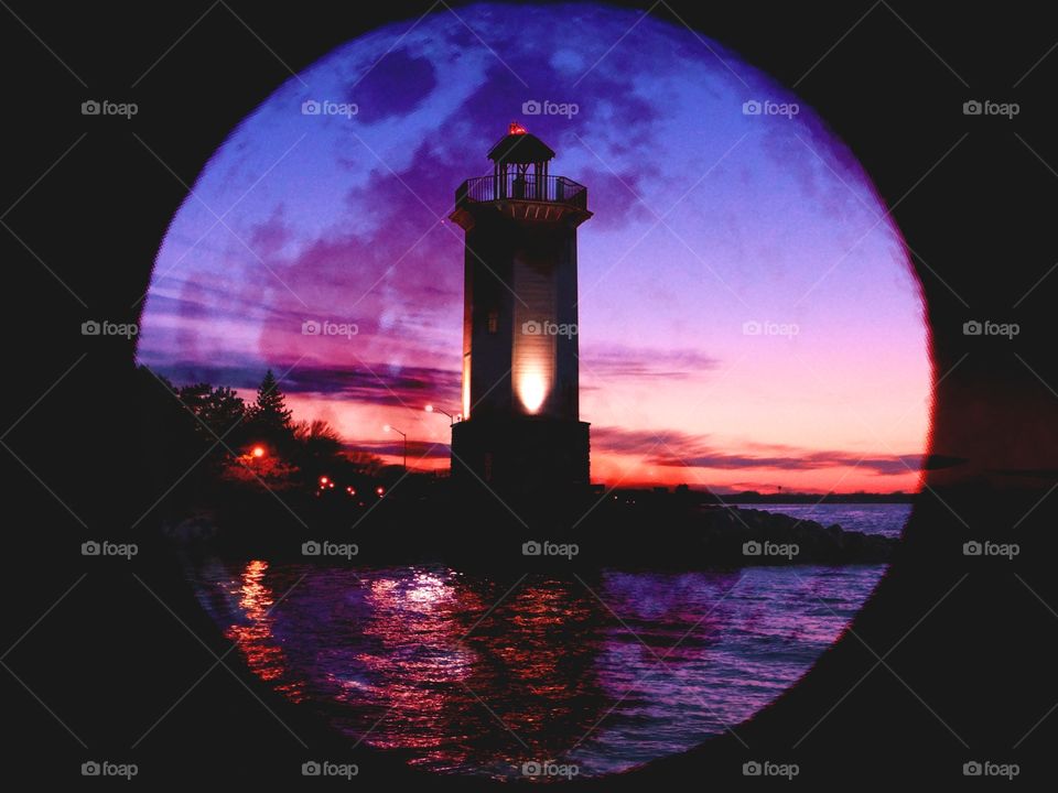 sunset over fond da lac Wisconsin lighthouse with moon shadow layer