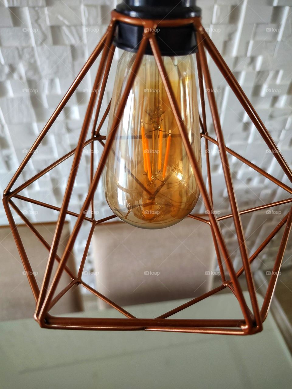 several triangles together in various positions form this lamp.