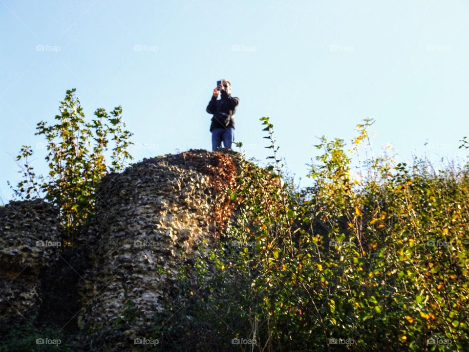 Man taking a photo on the hill