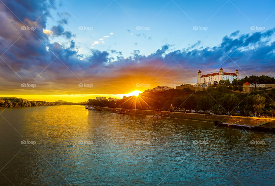 Amazing sunset at Danube river with view of Bratislava castle in Slovakia