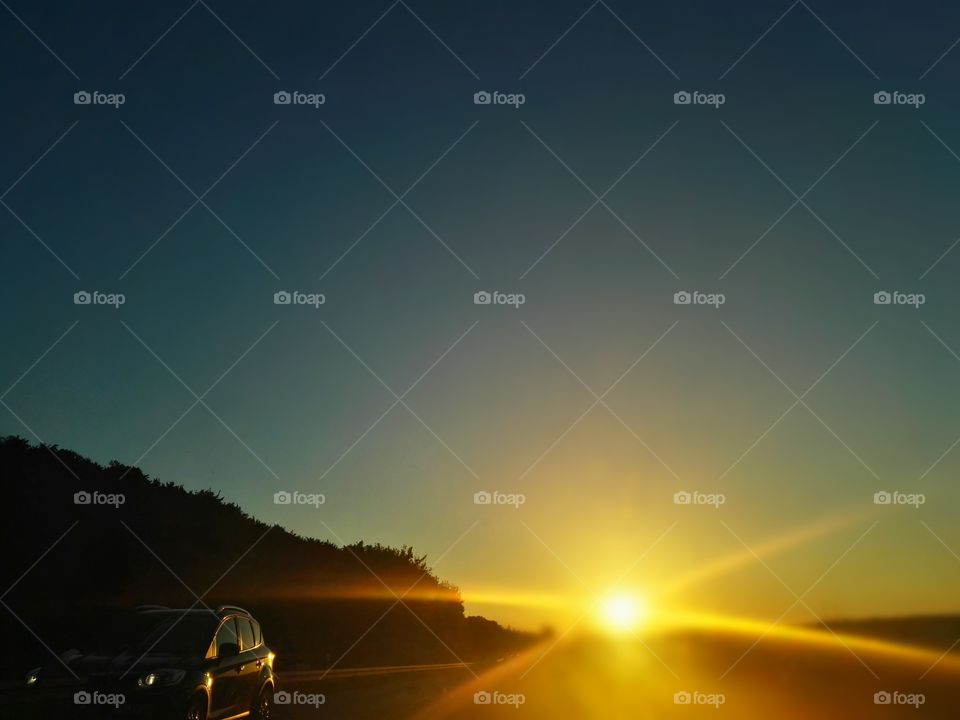 driving car during sunset