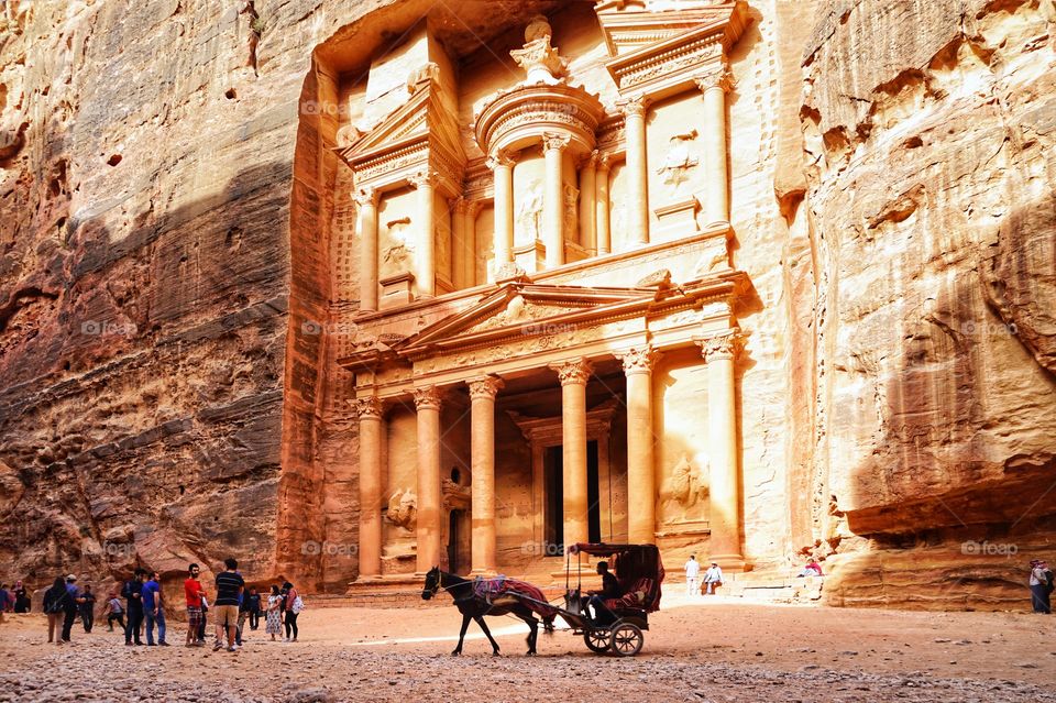 a group of tourists at treasury building in petra of Jordan