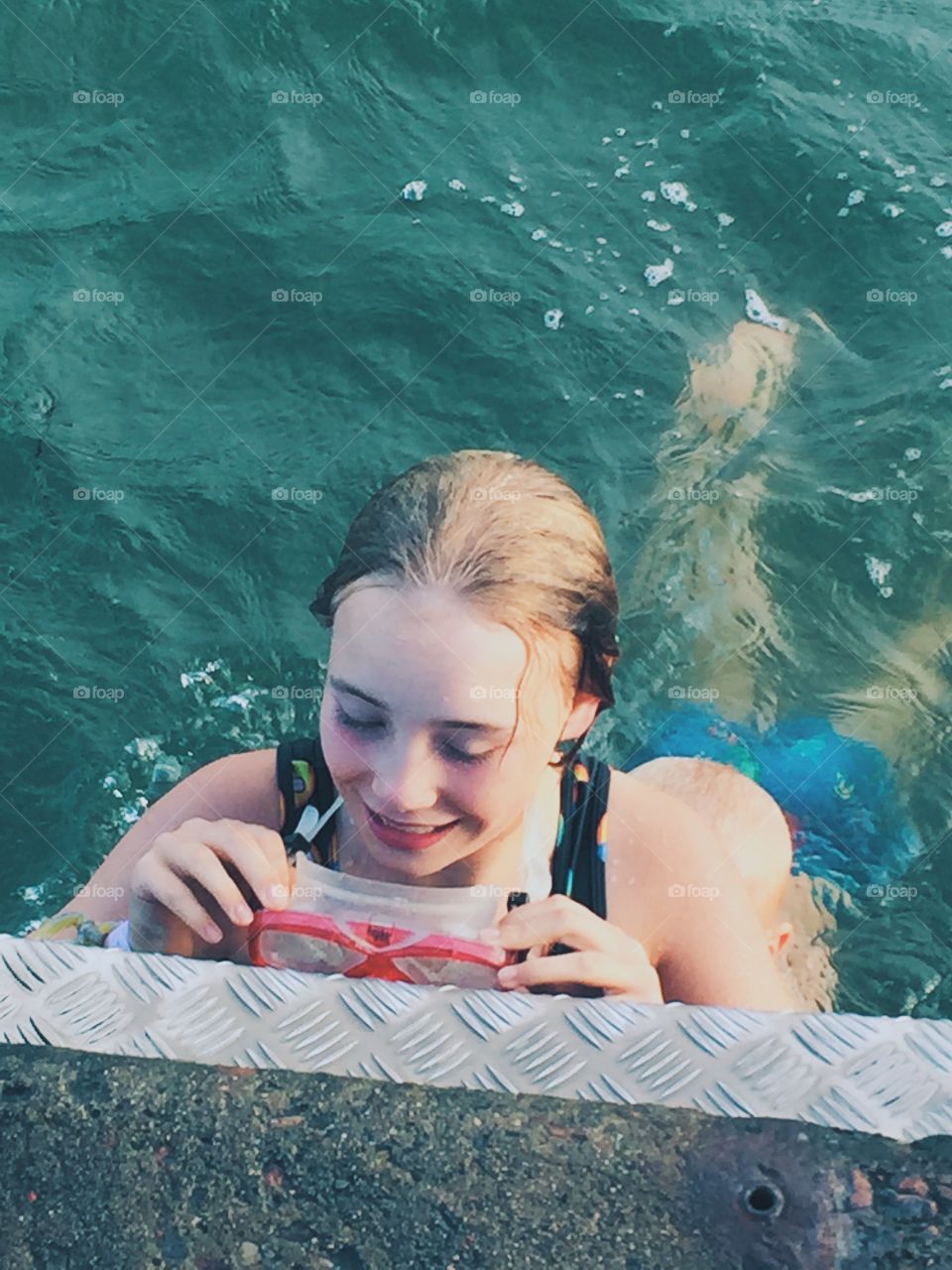 Happy girl bathing in the ocean