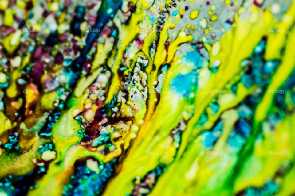 The ink to refill the printer cartridge was spilled onto the white washbasin and the paints blended into abstract drips and patterns.