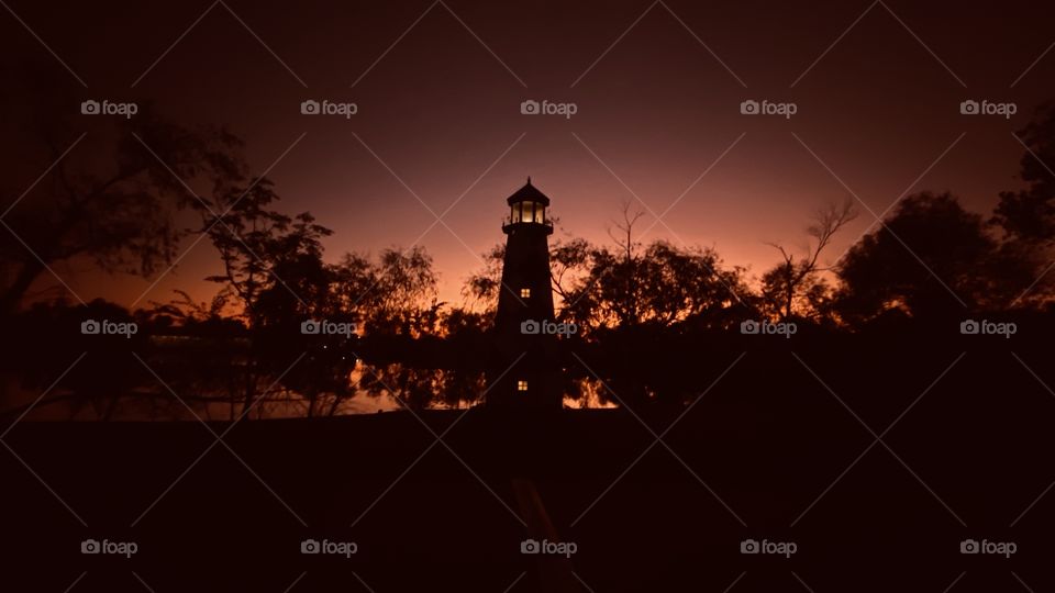 This Lighthouse is gleaming even though the night sky is taking over with surrounding Darkness. 
