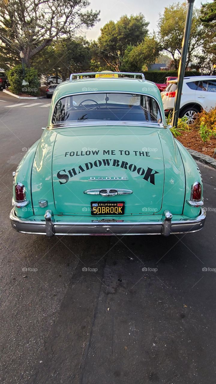 Mint green vintage checkered taxicab waiting for passengers 