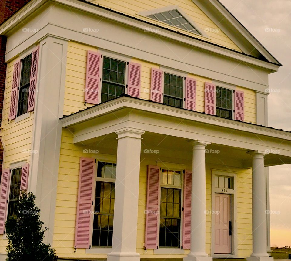 Pink Shutters on Yellow House