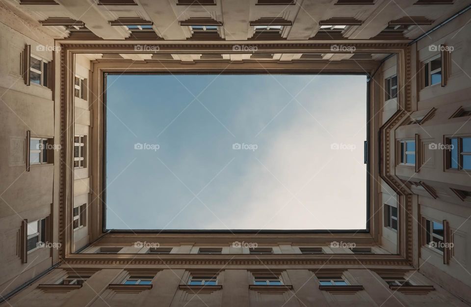 Directly below view of sky above residential building